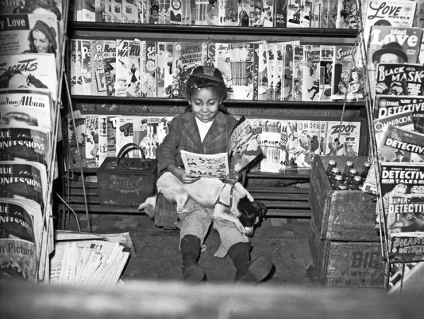 Girl reading comic book in newsstand by Charles "Teenie" Harris, 1940
